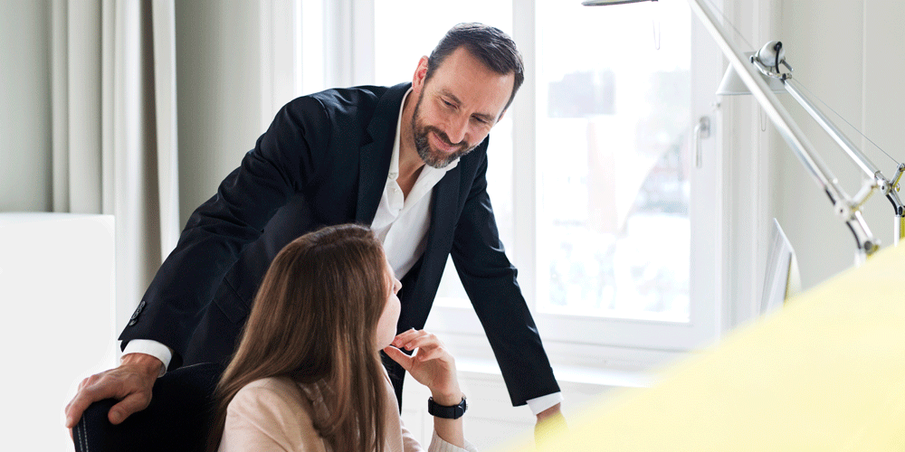 Boss talking calmly to staff member.